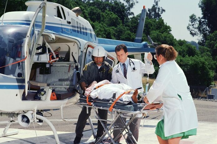 Medical Team Transporting Patient to Helicopter